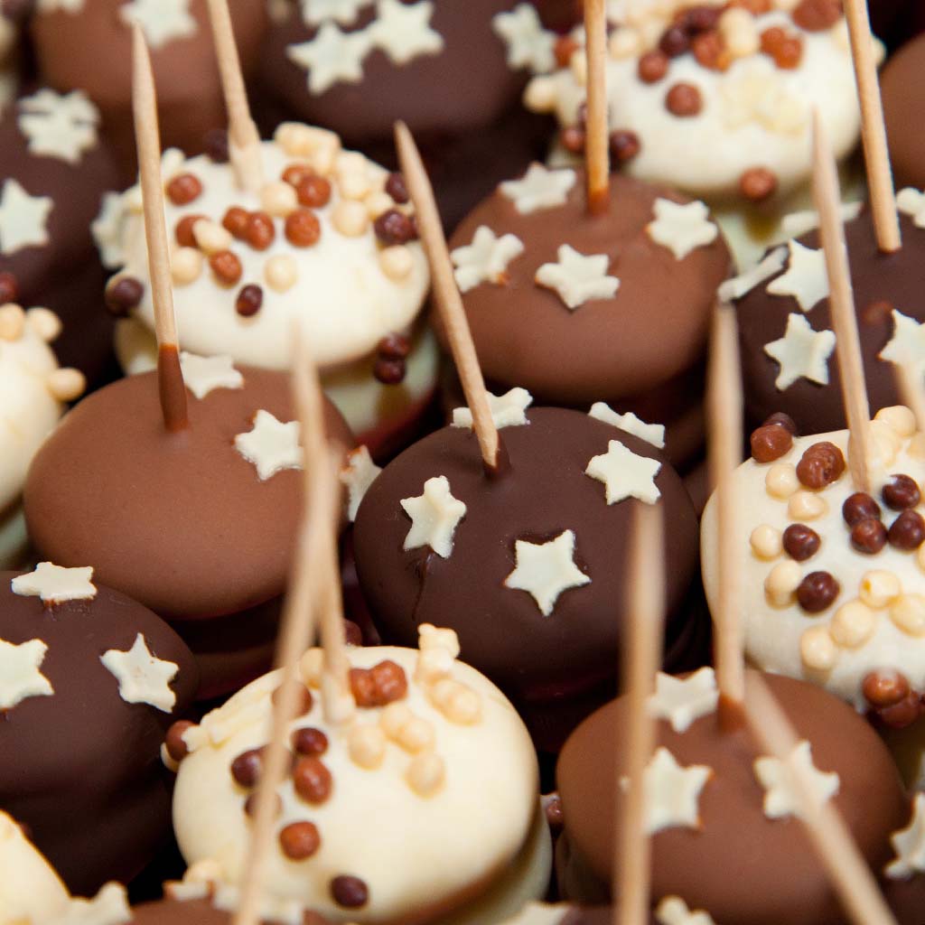 Closeup on chocolate lollipops adorned with star-shaped chocolate sprinkles