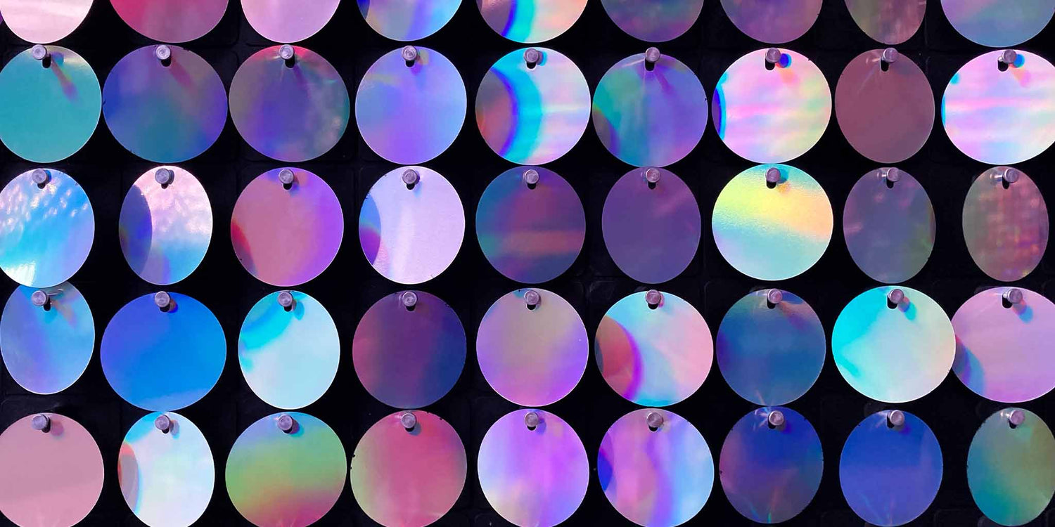 Lots of shiny, reflective purple circles linked together like glamorous chain mail