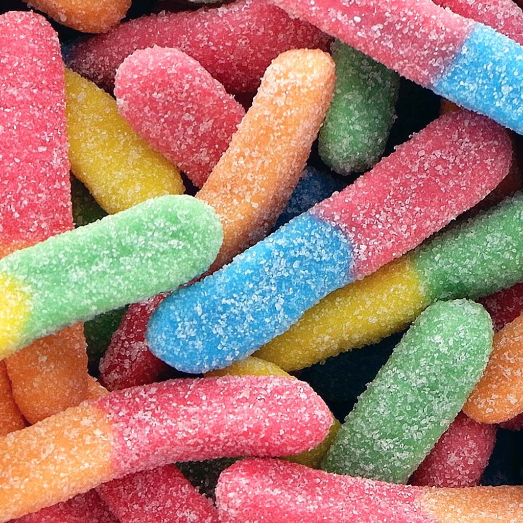 Closeup on a mass of colourful, sugar-covered sour gummy worms.